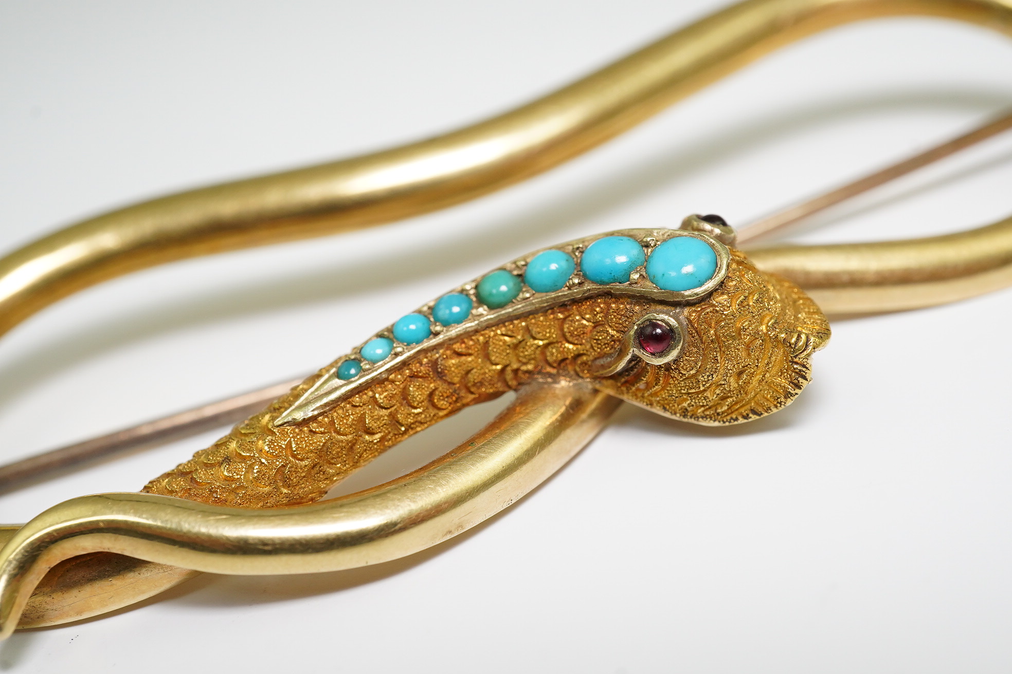 A Victorian gold, turquoise and cabochon gem set open work serpent brooch